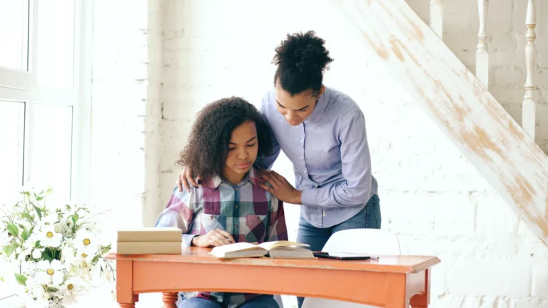 Mother helping her daughter with homework at home