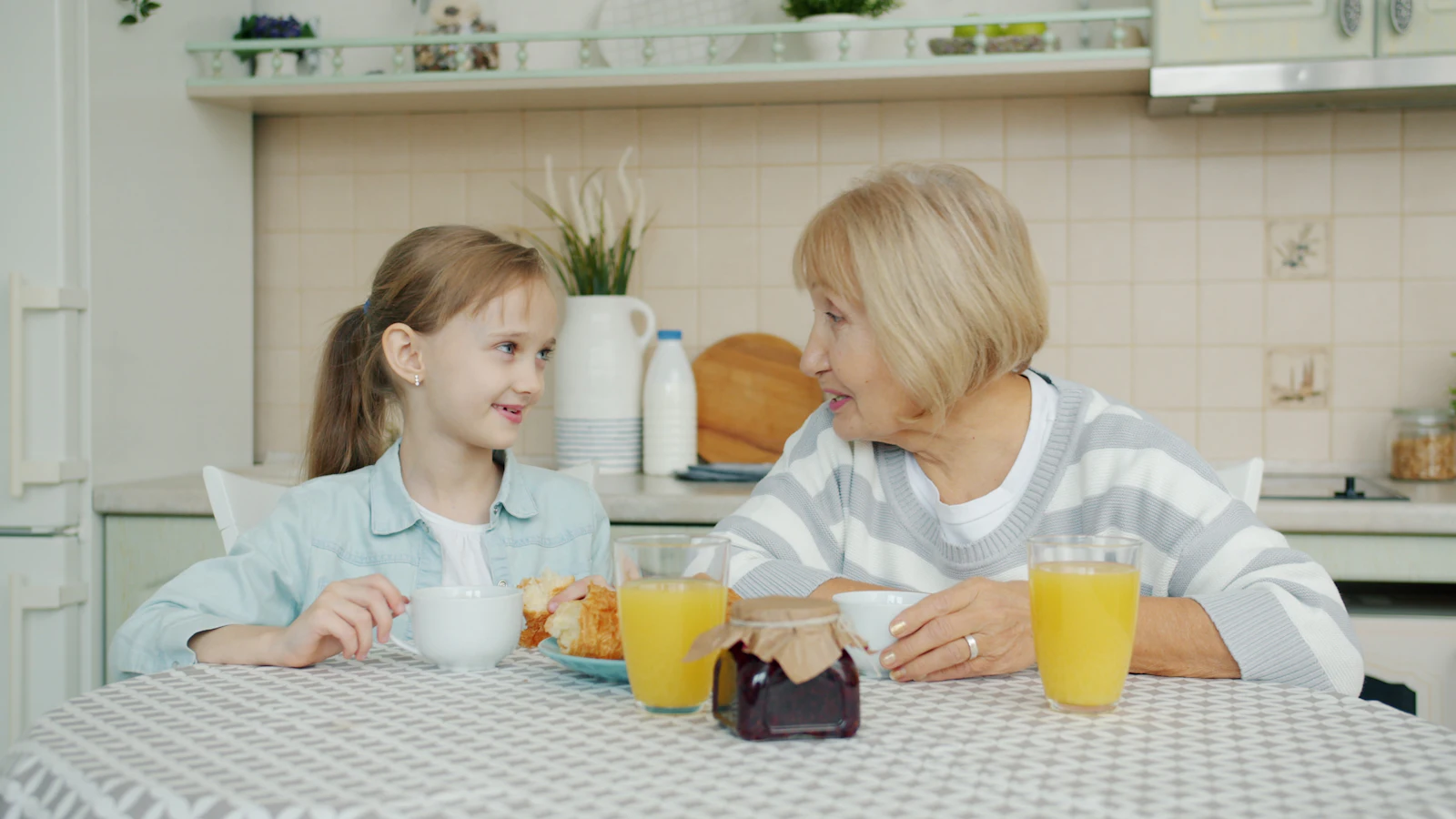 Grandmother and granddaughter having breakfast together